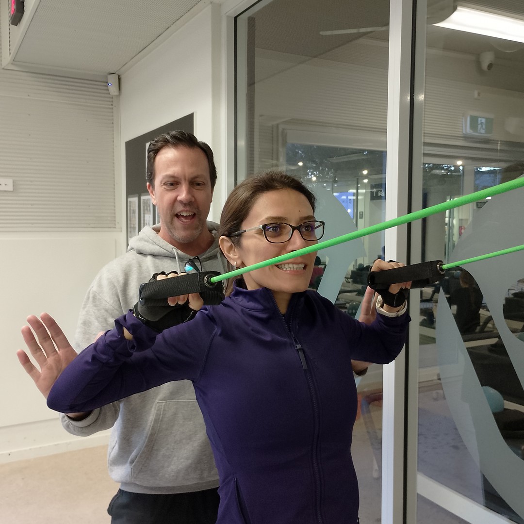 Nasim training with resistance bands under Aaron's coaching